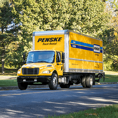 Yellow Penske box truck on road