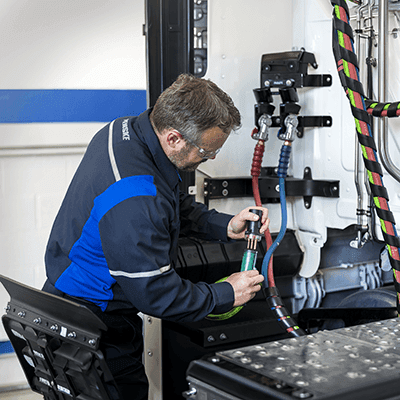 Maintenance technician working on a Penske truck
