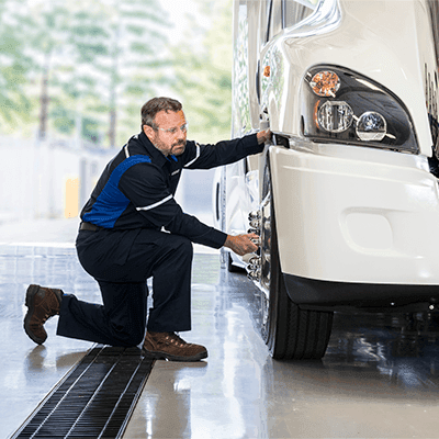 Penske maintenance technician working on a truck