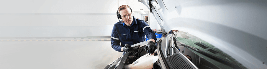 Penske maintenance technician working on a truck